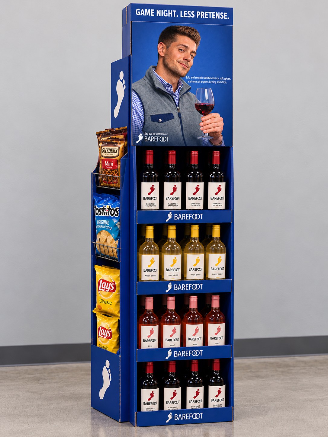 Mockup of the game night ad on a Barefoot retail display stocked with wine and snacks, headlined "Game night. Less pretense."