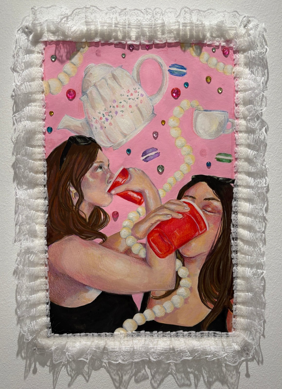 Mixed media painting of two women drinking from red cups under a floating teapot and pearls, framed in white lace and gems.